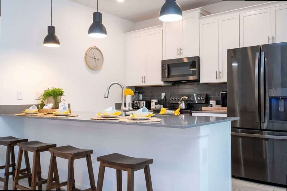 Whip up delicious meals in this bright, modern kitchen with sleek appliances, ample counter space, and seating for four at the stylish breakfast bar.