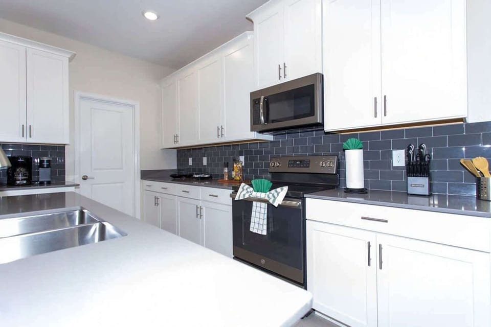 Whip up your favorite meals in this sleek, fully equipped kitchen with stainless steel appliances and contemporary finishes-ideal for home-cooked feasts!