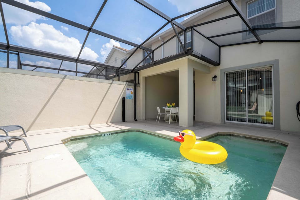 Step outside to a sunny, screened patio with a refreshing pool and plenty of space for poolside dining and relaxation-perfect for family fun!