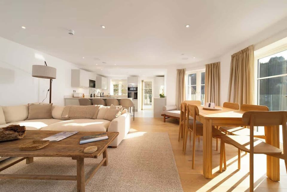 Experience the expansive elegance of our open-plan living room, which is built for comfort and easy relaxation in the centre of your stay.