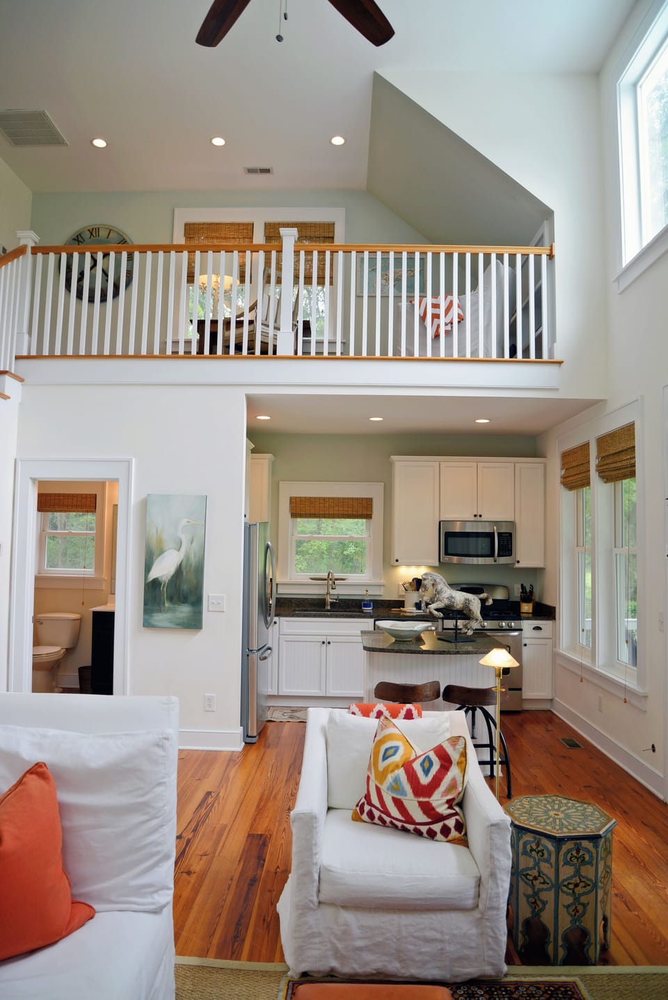 Open floor plan with half-bath down and windows throughout