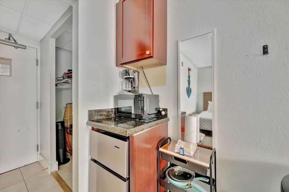 Compact kitchenette with modern appliances for easy meals and snacks. Perfect for your convenience and comfort during your stay.
