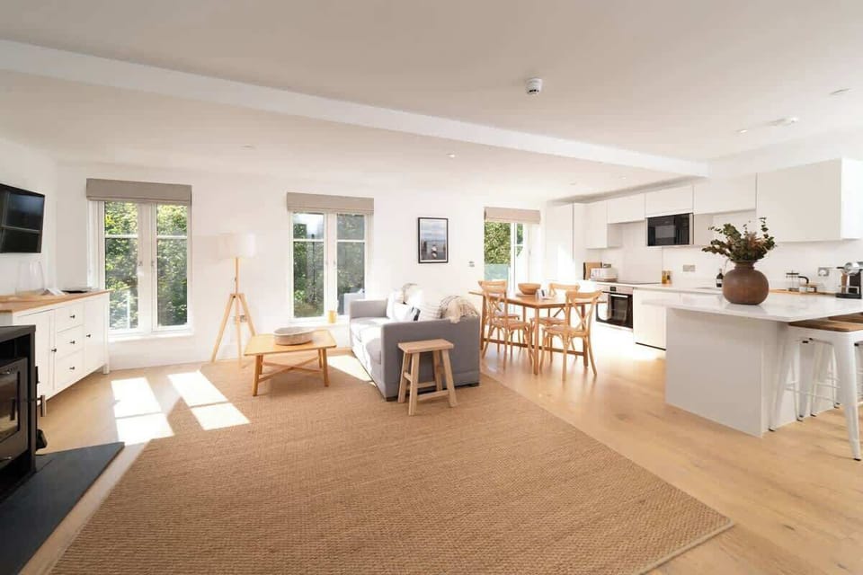 Experience the expansive elegance of our open-plan living room, which is built for comfort and easy relaxation in the centre of your stay.