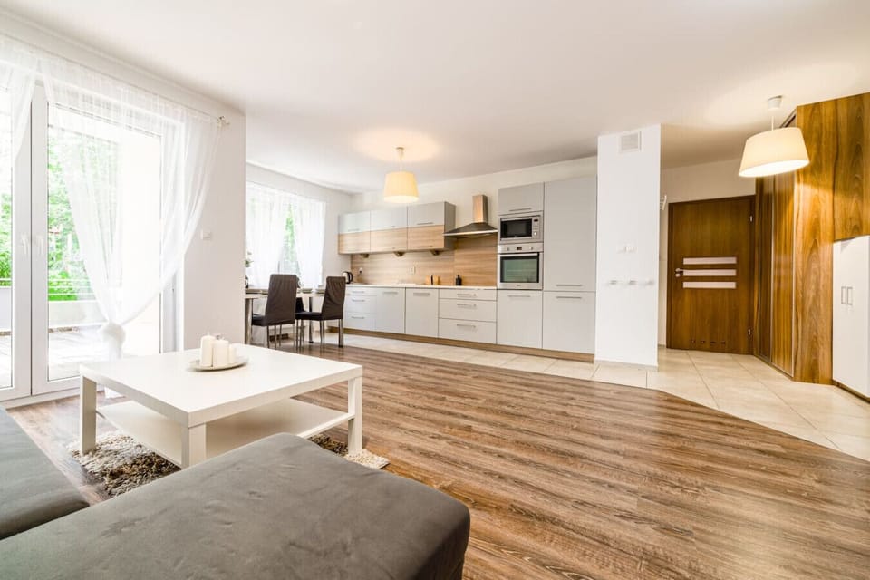 Comfortable living room with smart TV and terrace access | Book Now with RENTUJEMY