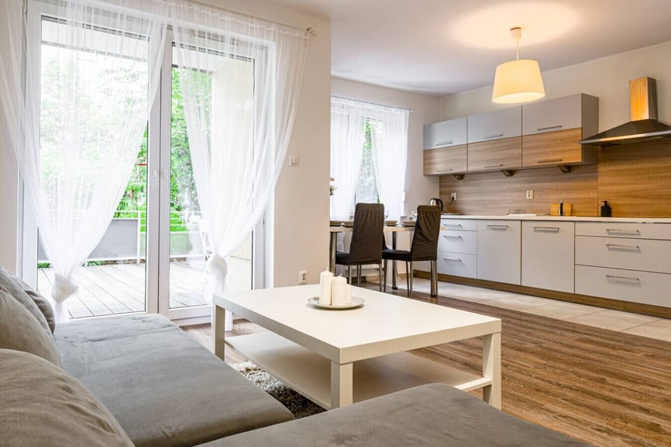 Comfortable living room with smart TV and terrace access | Book Now with RENTUJEMY