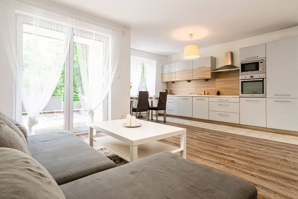 Comfortable living room with smart TV and terrace access | Book Now with RENTUJEMY
