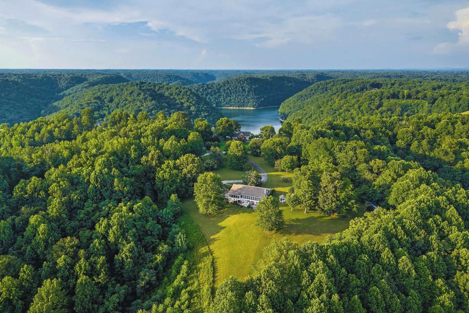 Thirteen acres of total privacy, with Center Hill Lake just beyond the treetops.