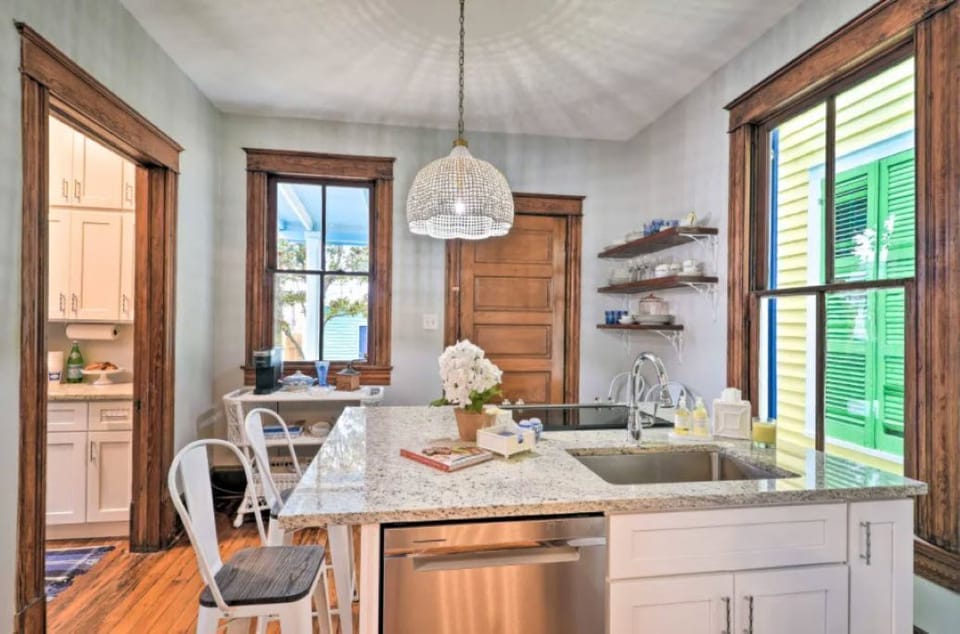 Bright kitchen with granite island and stainless appliances
