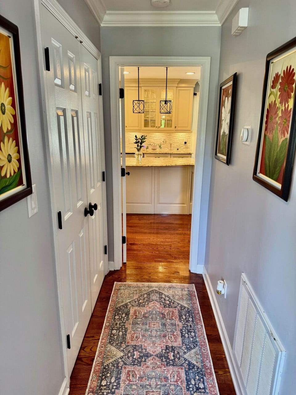 Front entrance. To the left is the formal living room, straight ahead to kitchen, to the right is the stairs to upstairs.