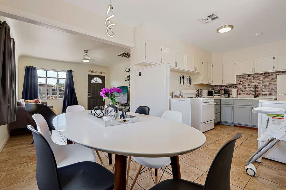 Small dining table with chairs and open Kitchen