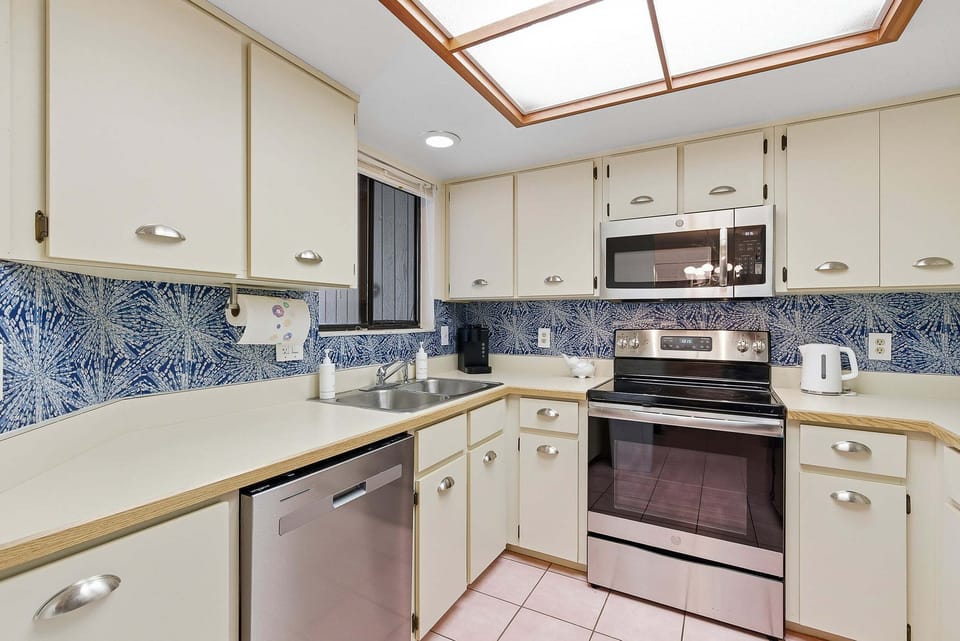 Prepare fresh meals in this bright, fully equipped kitchen featuring stainless steel appliances, ample counter space, and coastal-inspired design. Everything you need for a convenient and comfortable beach stay getaway.