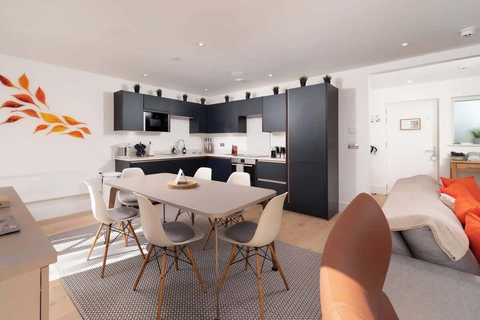 Cook in style in the deep blue open-plan kitchen, where modern design meets functionality for a sleek and inviting space.