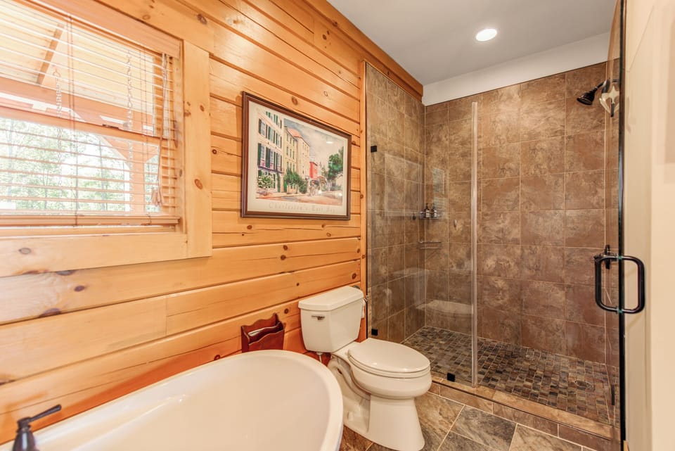 Upstairs ensuite bathroom with dual sinks, floating tub, and walk-in shower