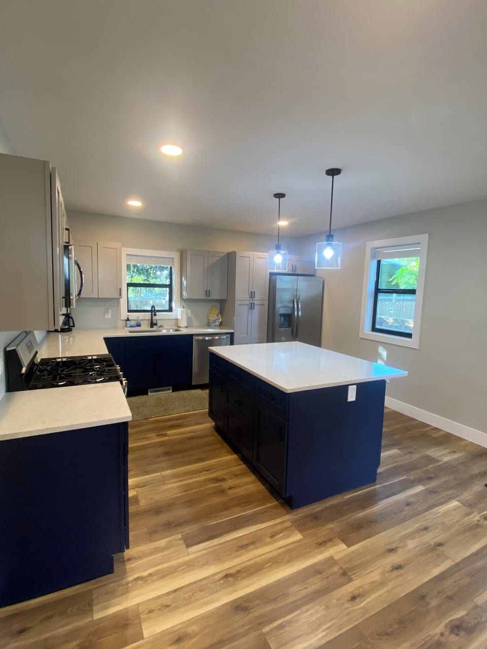 New kitchen with stainless appliances and seating for 3 at the island. 
