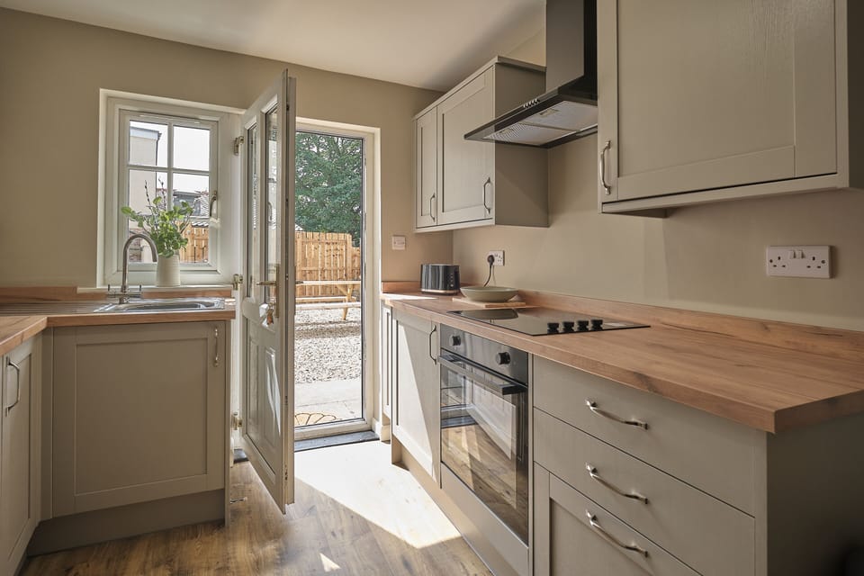 kitchen with access to back garden