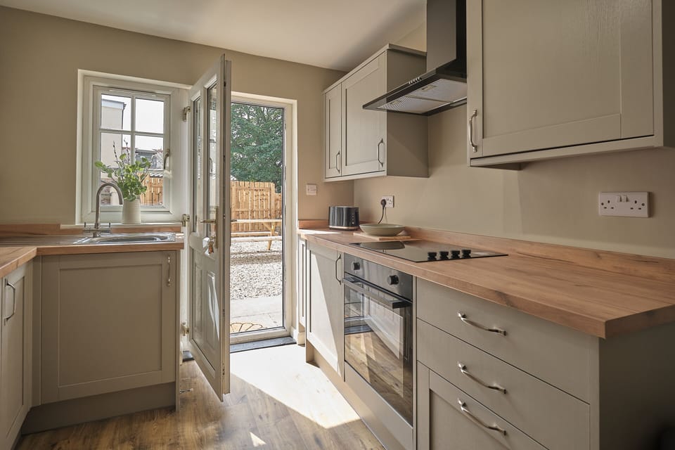 kitchen with access to back garden