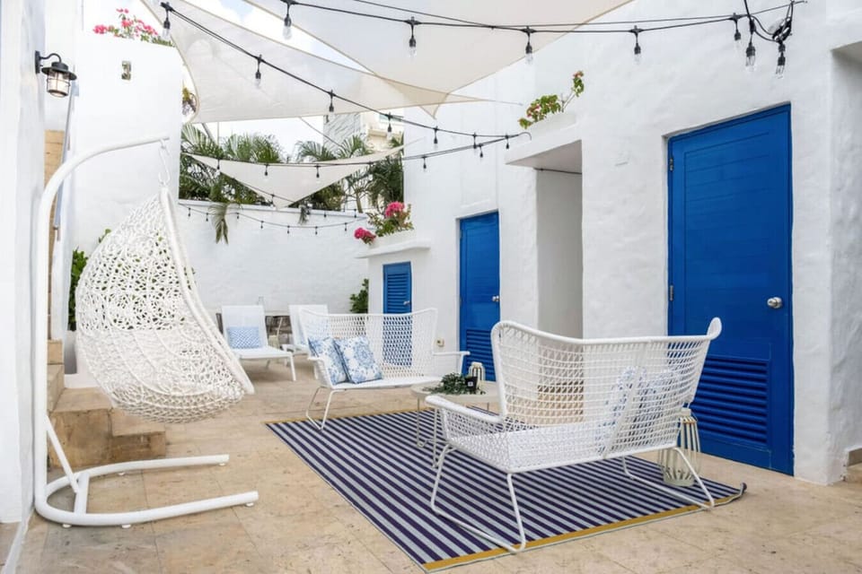 Shared backyard features pool, lounge area outdoors, BBQ and shade.