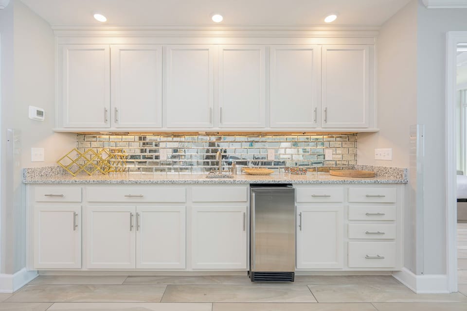 Enjoy chilling drinks from the mini fridge and admiring the gleaming mirrored backsplash at the wet bar