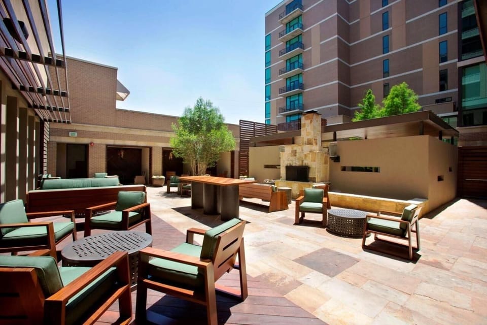 Linger outdoors on cushioned seating around a cozy fire feature.