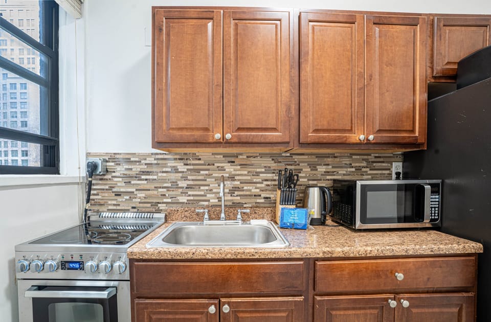Well-equipped kitchen with stove, microwave, and essentials