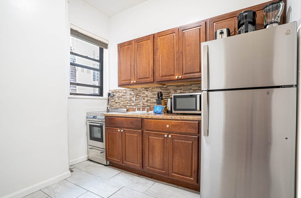 Modern kitchen with full appliances, microwave, and coffee maker