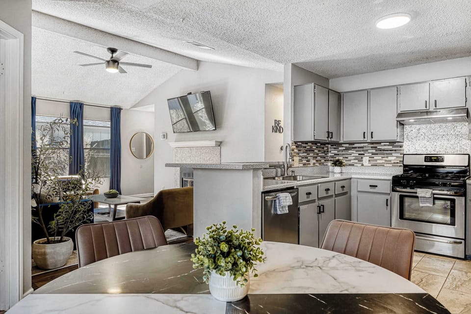 Open dining and kitchen layout with marble table seating, perfect for gathering, cooking, and staying connected
