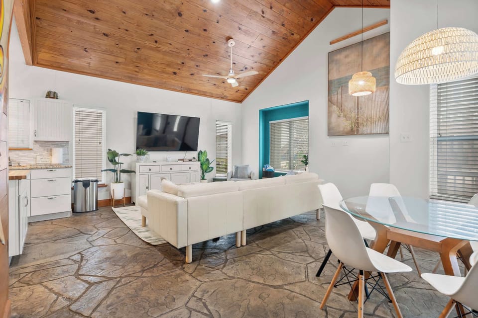 Open-concept living area with vaulted ceilings and elegant beach-house charm.