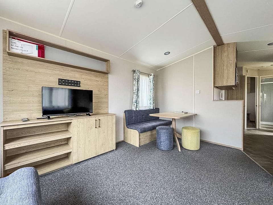 Cozy living area with modern entertainment and dining nook