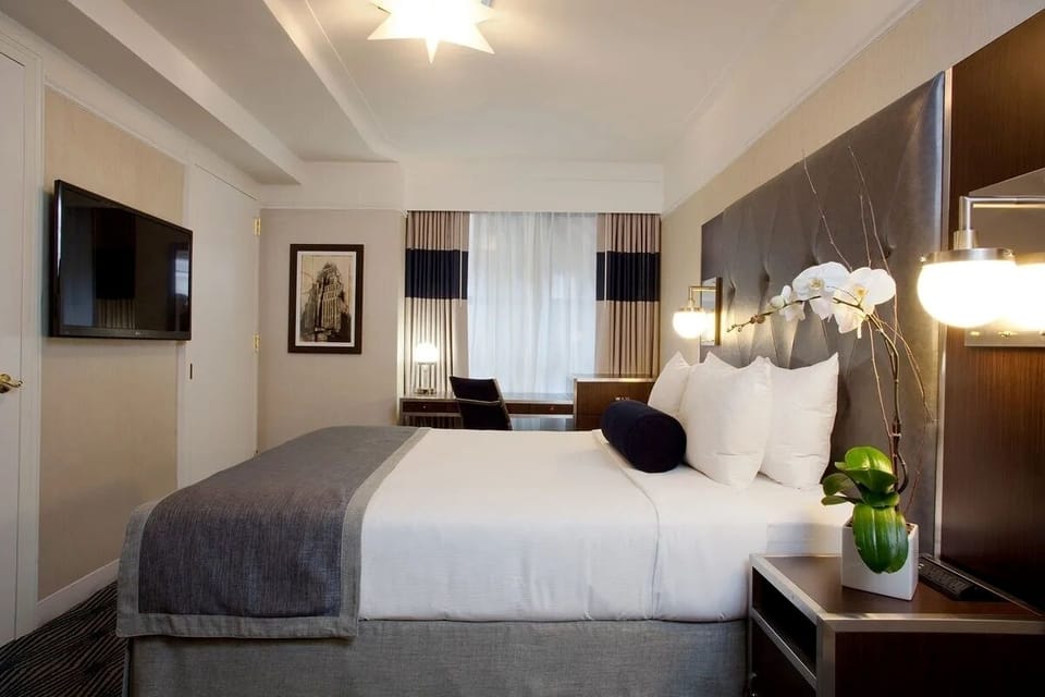 Lounge in a suite-style room with seating and skyline views.