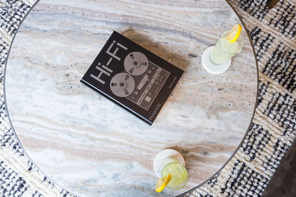 Unit 2: Bright living room with comfortable seating, smart TV, designer decor, and access to the private patio.