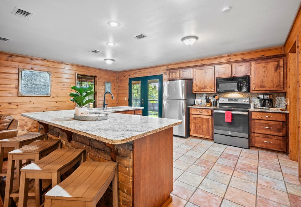 The kitchen island doubles as a breakfast bar with room for the whole group.