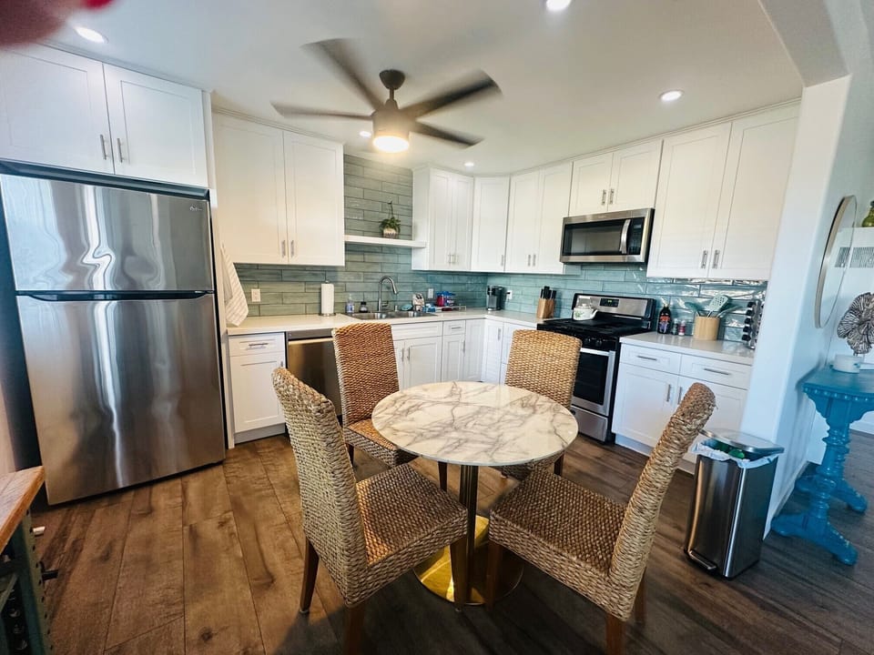 Open concept kitchen with Keurig, gas stove, fridge/dishwasher 