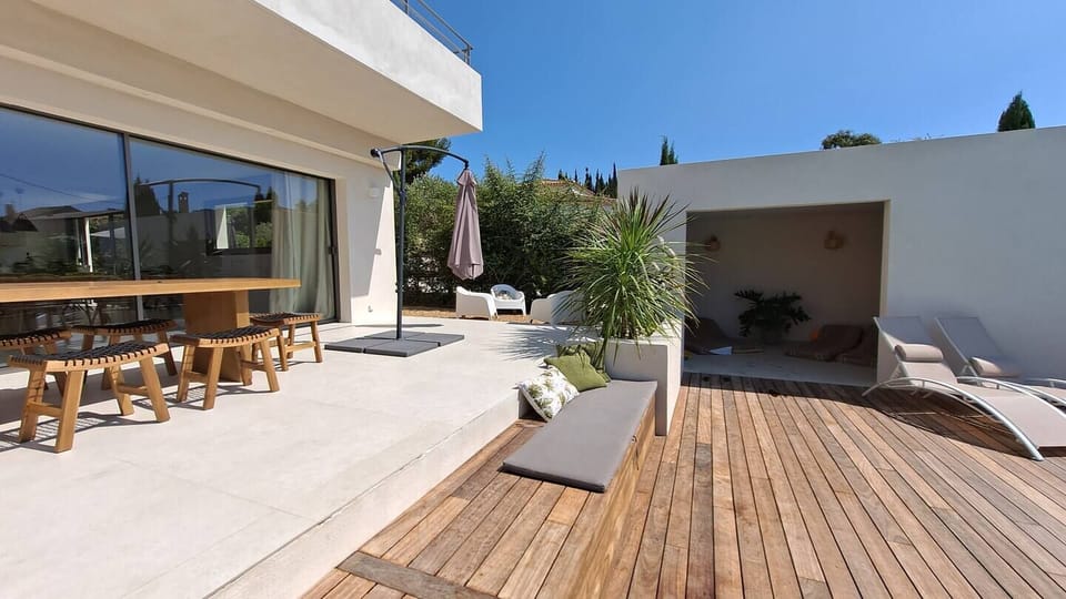 villa; terrace; deckchair; garden; parasol