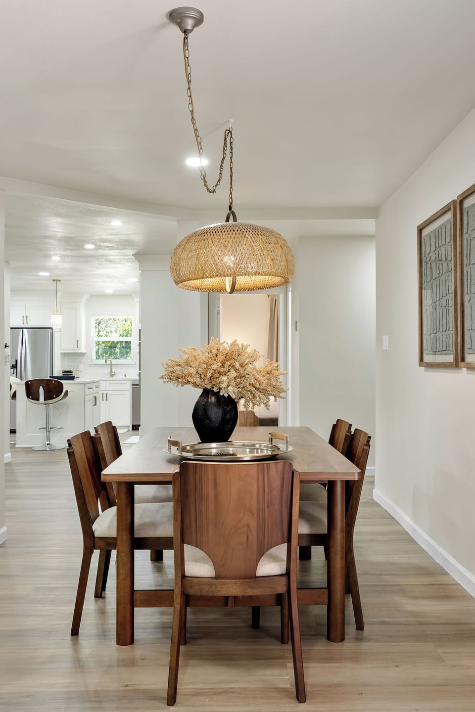 Host elegant dinners in this spacious dining area. With ample seating and a beautiful chandelier, it's the perfect setting for memorable meals and engaging conversations.