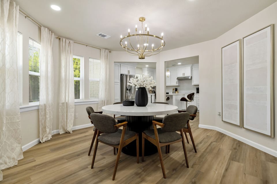 Chic casual dining. This elegant round dining area, bathed in natural light, offers a charming and spacious spot for breakfast, casual meals, or lively conversations, perfectly complementing the main dining space.
