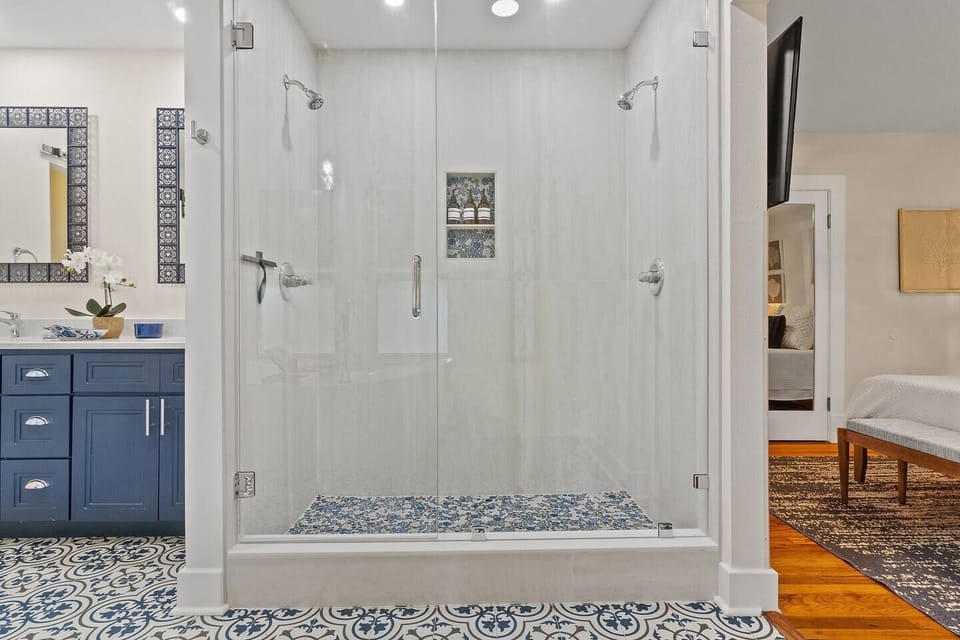 Generous double-head shower with modern fixtures provides convenience for families staying near downtown Pensacola and beach.