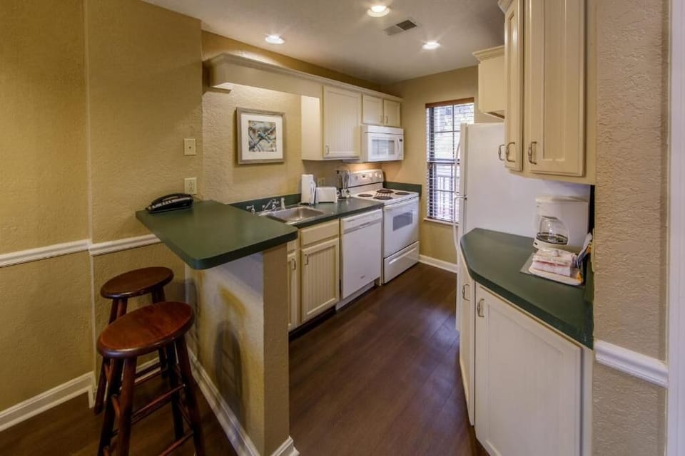 Cook simple favorites in the bright kitchen with handy breakfast bar.