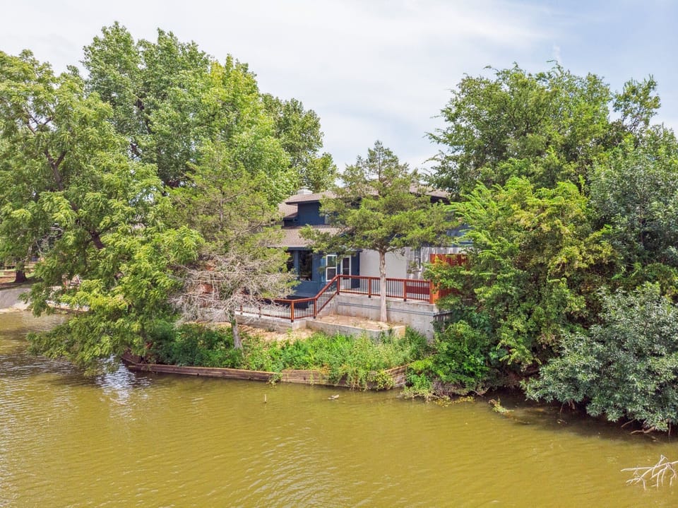 Modern lakefront home with a private deck—relax and enjoy scenic water views surrounded by beautiful trees