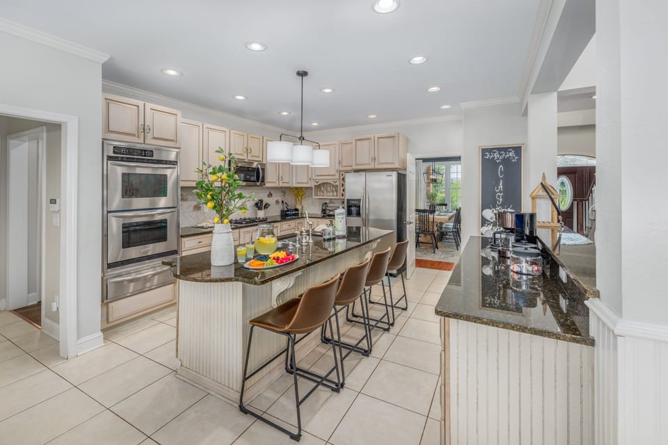  Spacious kitchen with island seating and modern appliances.