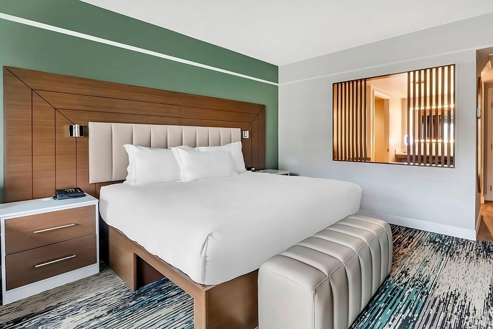 Sink into a plush king bed with modern headboard lighting.