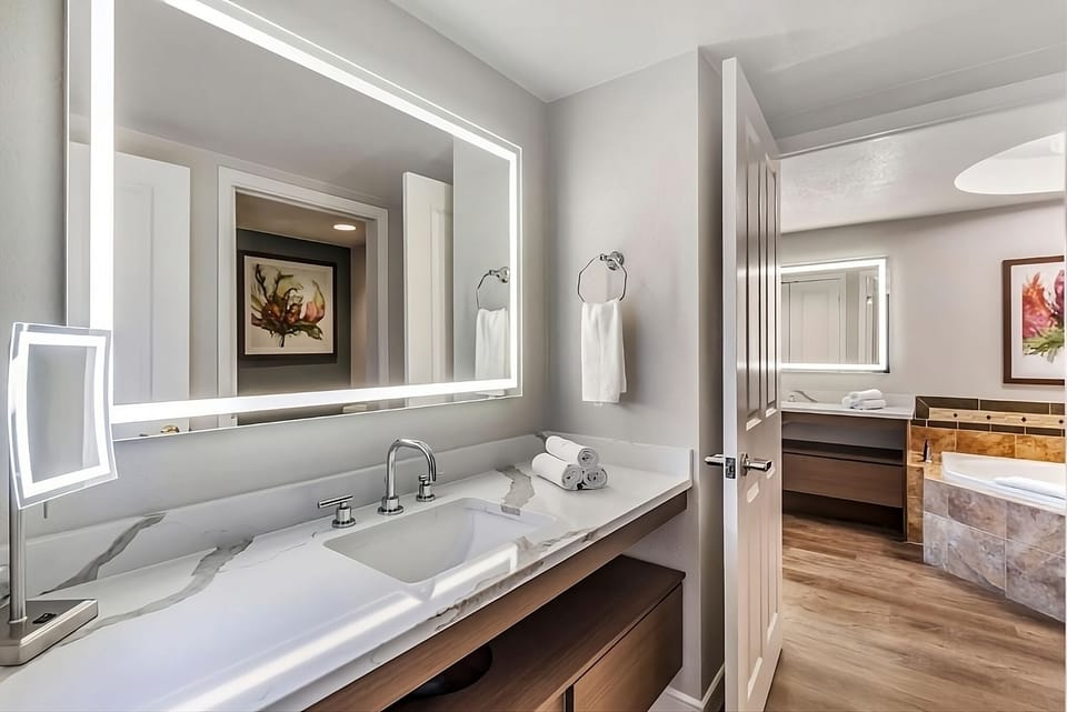 Refresh at a sleek vanity with bright, flattering mirror lighting.
