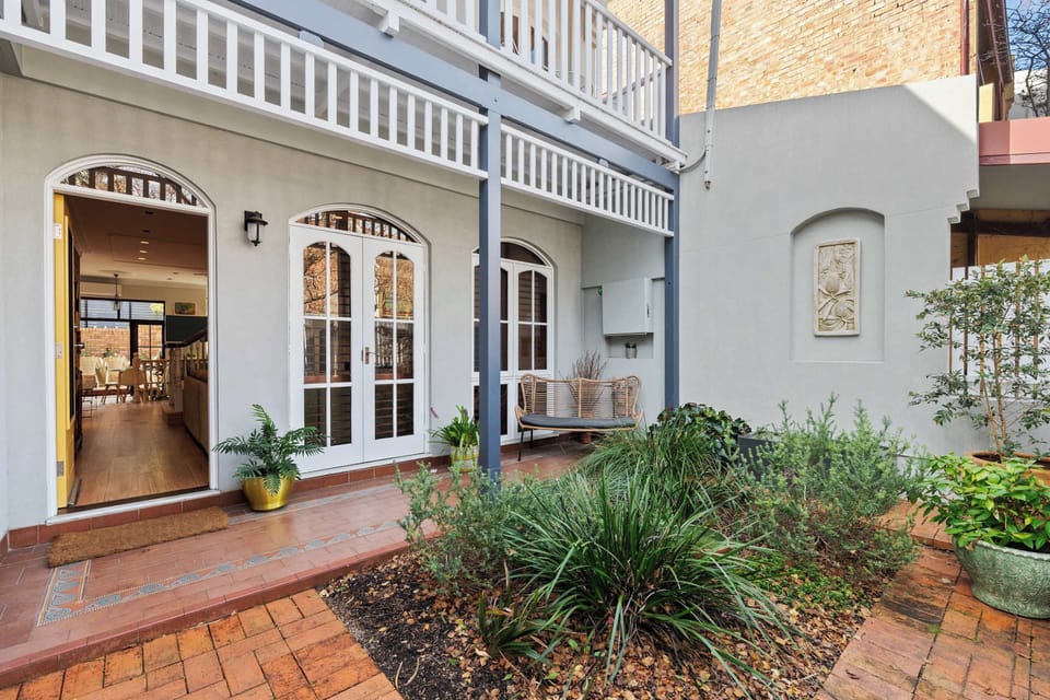 A charming porch with a single seat designed to comfortably accommodate up to two guests, perfect for relaxing together.