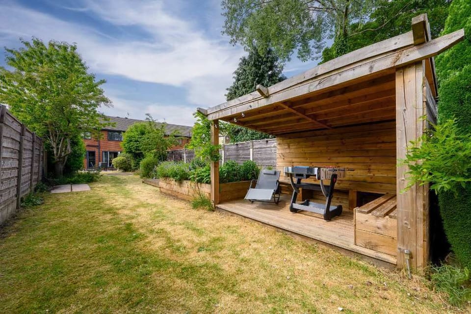 Private rear garden with covered seating area, perfect for enjoying a morning coffee or evening barbecue in the warmer months