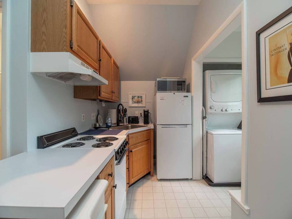 Upstairs efficiency kitchen with range, microwave, convection oven and fridge 