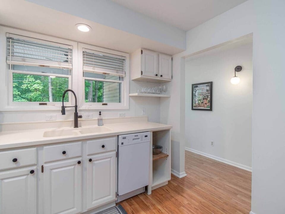 Downstairs kitchen looking out on front porch and wooded space