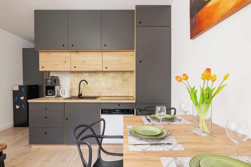 Fully equipped kitchenette with kitchen appliances and dining area.