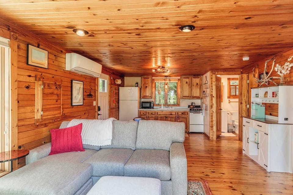 Cozy and charming open-concept living room and kitchen in our 450 sq ft waterfront cottage—compact yet thoughtfully designed for comfort and relaxation during your Door County getaway.