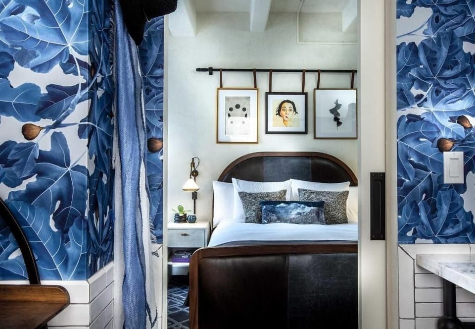 Tuck into a cozy alcove framed by bold, moody wallpaper.