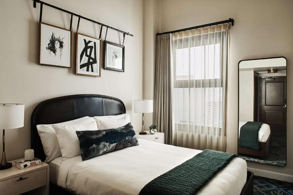 Unwind in crisp linens beneath art-filled, sunlit windows.