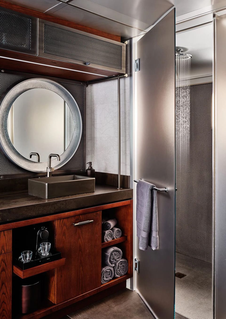 Indulge in a sleek vanity and rainfall shower experience.